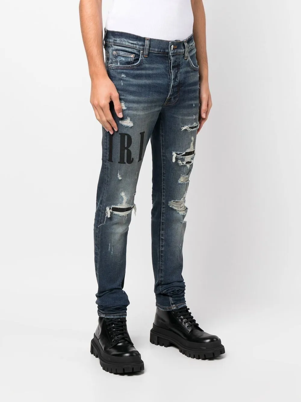 AMIRI distressed logo-print skinny jeans